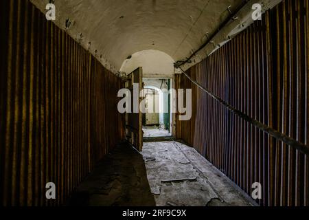 Old vaulted corridor of Soviet bunker, echo of Cold War. Stock Photo