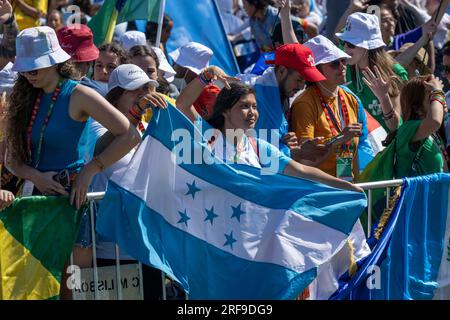 Lisbon, Portugal. 01st Aug, 2023. Female youths are seen carrying a Honduran flag prior to the inauguration of the World Youth Day meeting in Lisbon. This religious activity is a worldwide meeting of young people with the Pope and takes place every two, three or four years on an international basis in a city chosen by the Supreme Pontiff. (Photo by Jorge Castellanos/SOPA Images/Sipa USA) Credit: Sipa USA/Alamy Live News Stock Photo