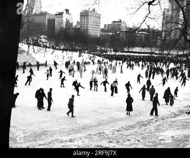 New York, New York:  c. 1938 Ice skaters at the Winter Sports Carnival on the 59th St. lake in Central Park. The carnival was sponsored by the Dept. of Parks. Stock Photo
