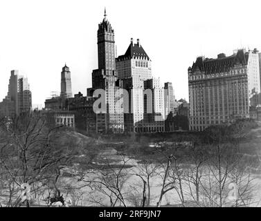 New York, New York:  c. 1928 The view from across the Duck Pond of New York City's crown jewel hotels where they sit on the southeast edge of Manhattan's Central Park. The Plaza Hotel on 59th Street is on the right, and on Fifth Avenue is the tall Hotel Netherland near the center and the Hotel Savoy to the right. Stock Photo