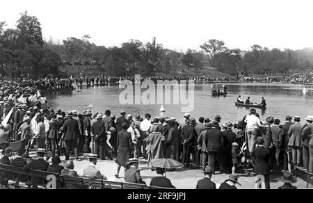 New York, New York:  May 22, 1926 The Juvenile Regatta gets under way on Conservatory Lake in New York's Central Park. Hundreds of fans throng to see the boats, 15 inches through 72 inches, sail across the lake in exciting competition. Stock Photo