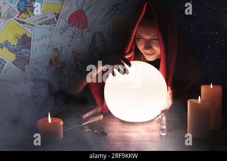 Double exposure with tarot cards and photo of soothsayer using crystal ball Stock Photo