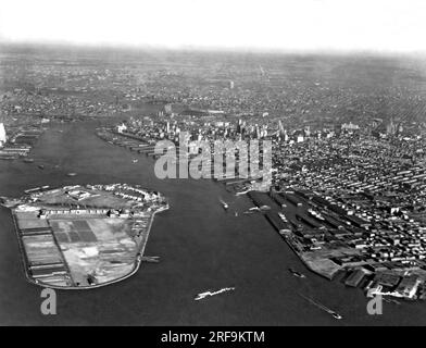 New York, New York:  c. 1922 Governors Island in New York Harbor. Brooklyn is a quarter mile away on the right and Battery Park in Manhattan is a half mile to the left. Stock Photo