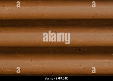 brown color painted wavy undulations on tin background Stock Photo