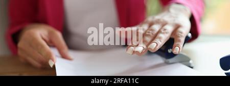 Close-up image of business woman working with documents in office. Stock Photo