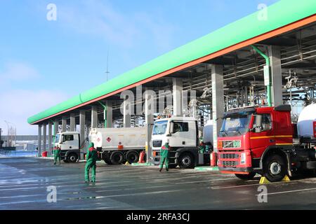 Large green industrial gas station for refueling vehicles, trucks and tanks with fuel, gasoline and diesel in the winter. Stock Photo