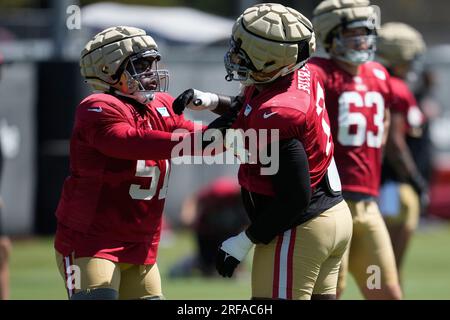 San Francisco 49ers center Jason Poe, left, and Minnesota Vikings tackle Christian  Darrisaw trade jerseys and pose for a photo after a preseason NFL football  game, Saturday, Aug. 20, 2022, in Minneapolis. (