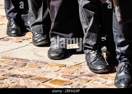 View of the feet of the nazarenes in a religious procession during the holy week of Zamora in Spain. Stock Photo