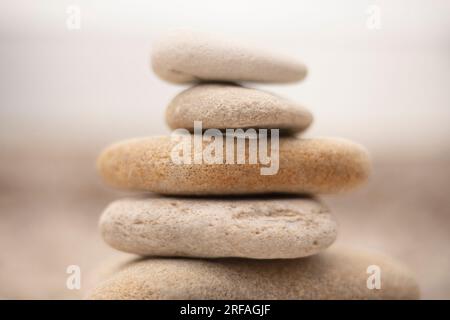 Pile of zen-like white stones on the beach that invite calm and reflection Stock Photo