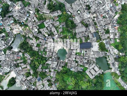 Jinhua. 1st Aug, 2023. This aerial photo taken on Aug. 1, 2023 shows the Zhuge Village of Lanxi City, east China's Zhejiang Province. The Zhuge Village, a historic gem with over 300 ancient buildings dating back to Ming and Qing dynasties (1368-1911), is home to descendents of Zhuge Liang, a renowned military strategist in the Three Kingdom Period (220-280). The village has made concerted efforts to preserve the ancient heritages and develop tourism, receiving over 500,000 visitors annually. Credit: Weng Xinyang/Xinhua/Alamy Live News Stock Photo