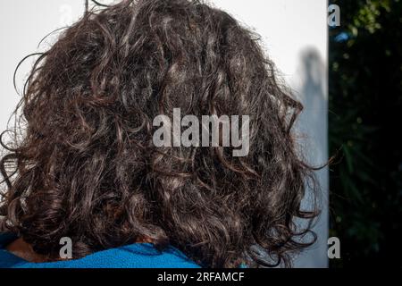 June 28th 2023 Uttarakhand India. Indian man with long, curly hair and dandruff issues in Uttarakhand, India. Stock Photo