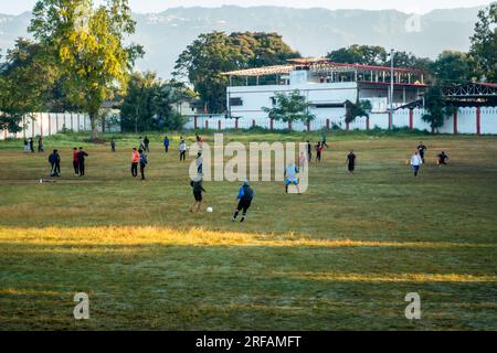 Oct.14th 2022 Uttarakhand, India. Middle-aged amateur men playing football in a stadium. Spirited match showcasing the love for the game and active sp Stock Photo