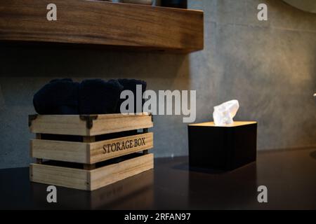 New modern white bathroom. Dark blue towels and tissue, selective focus. Stock Photo