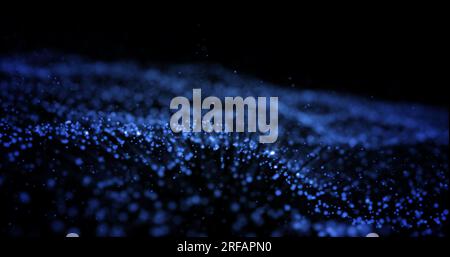 Abstract blue glowing energy waves from particles and magical dots with blur effect on dark background. Abstract background. Stock Photo