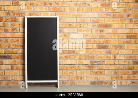Black sign in white frame and copy space on brick wall background Stock Photo