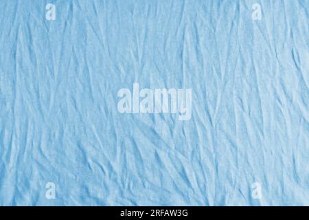 Wrinkled, crumpled blue fabric texture background. Wrinkled and creased abstract backdrop of cotton jersey textile, wallpaper with copy space, top vie Stock Photo