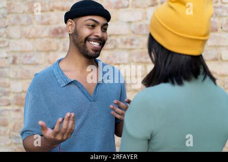 Laughing african american hipster man flirting with girlfriend outdoor in the city Stock Photo