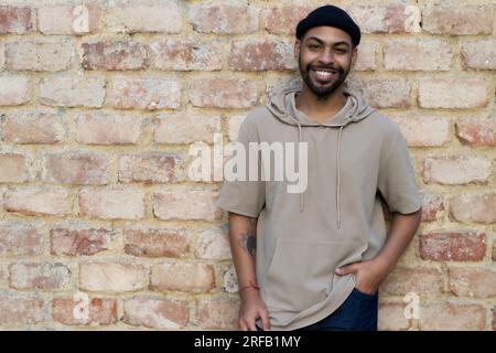 Happy african american man with cap and piercing outdoor in the city Stock Photo