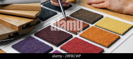 choosing flooring material color from carpet samples Stock Photo