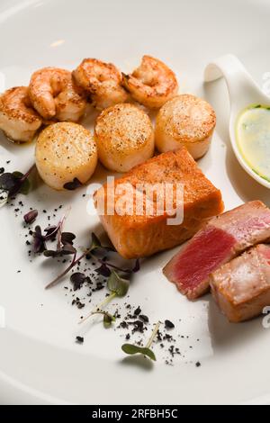 Assorted grilled seafood on a white plate. View from above. Stock Photo