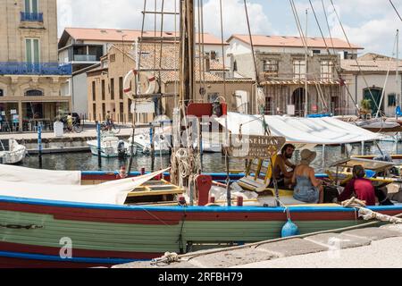 View of Port de Marseillan with moored pleasure boats along quayside, Herault, Occitanie, France Stock Photo