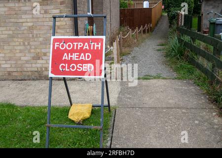 A red and white sign warning that a public footpath is closed for works Stock Photo