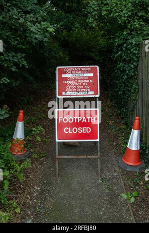 Red and white sign warning that a public footpath is closed for works Stock Photo