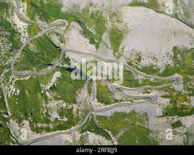 AERIAL VIEW. Winding road near Le Crey Barétaz leading to the famed Galibier Pass. Valloire, Savoie, Auvergne-Rhône-Alpes, France. Stock Photo