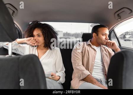 Displeased Middle Eastern Couple Expressing Unhappiness After Conflict In Car Stock Photo