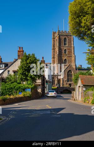 The tower of St Georges church Dunster with the houses on West st. Stock Photo