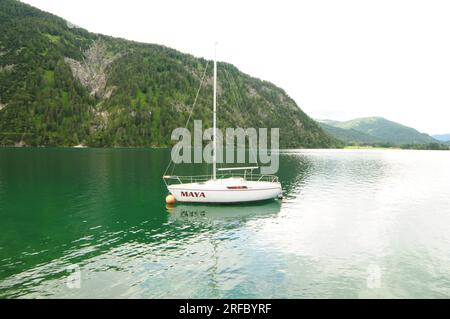 Boat in Achensee Lake in Austria, the Lake take reflecting the green mountain and taking the green color. Stock Photo