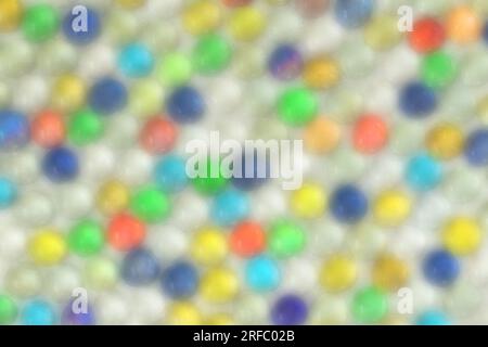 Abstract colorful defocused/blurred background. Bright colorful shiny background made up of many small artificial round crystals. Colorful texture. Stock Photo