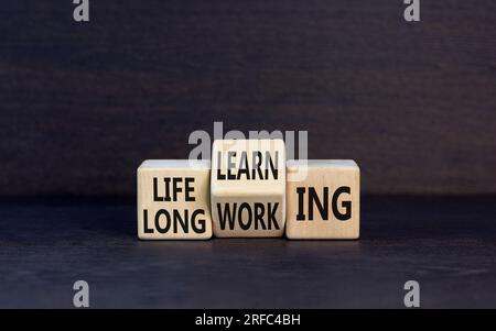 Lifelong learning working symbol. Concept word Lifelong learning working on block on a beautiful grey table grey background. Business educational life Stock Photo