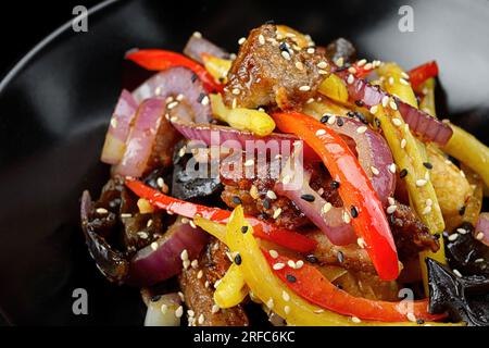Veal with vegetables and spices, on a dark background. Panasia Stock Photo
