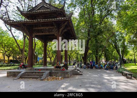 Hanoi, Vietnam - May 24, 2023: Lenin Park breathes tranquility amidst urban pulse. Lush greens embrace a lake, while afar, chess players congregate, t Stock Photo