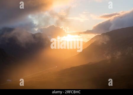 Striking light and clouds at sunset at the Pass of Glencoe from Beinn a' Chrulaiste , Scotland Stock Photo