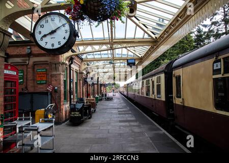 An early morning authentic heritage railway train, steam pulled about to depart from Loughborough station en route to Leicester North on the GCR Stock Photo