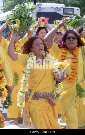 A group of devout HIndus dressed in ethnic clothing march from their temple in Ozone Park to the Arya Spiritual Grounds for a Fire Walking service. Stock Photo