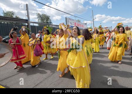 Cheer at the conclusion of a long Hindu parade from their temple in Ozone Park to the grounds of their fire walking ritual in Jamaica, Queens, NYC. Stock Photo