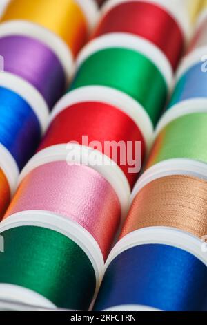 Background from spools with multicolored sewing threads Stock Photo
