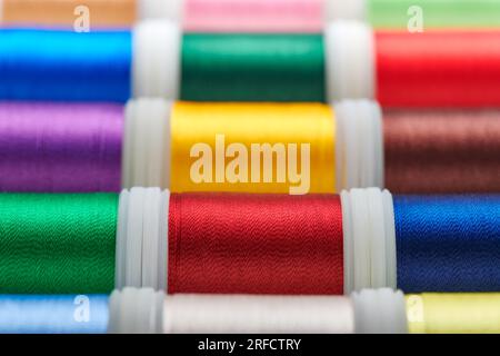 Background from spools with multicolored sewing threads Stock Photo