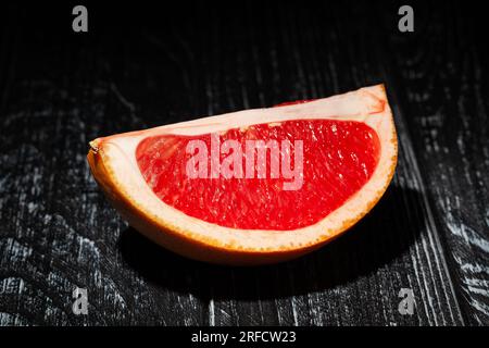 sliced grapefruit on wood background Stock Photo
