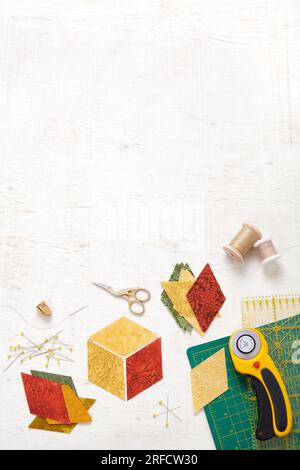 Accessories for quilting top view on a white surface. Space for text. Stock Photo