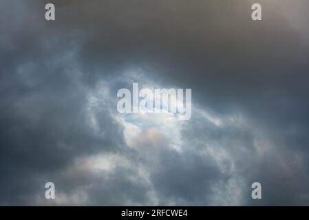 Layers of fast moving clouds on a humid summer evening. Stock Photo