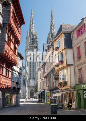 Quimper Brittany old quarter town Rue Kereon QUIMPER Cathedral spires in background. Visitors enjoying stroll on historic cobbled street. Quimper Stock Photo