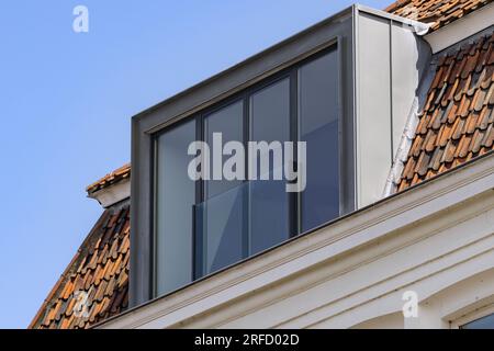 straight metal dormer on the roof of a historic building Stock Photo