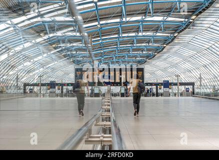 WATERLOO STATION single lone rail traveller in quiet new architecture surrounding platforms 20-24 in former Eurostar Terminal. Waterloo station London Stock Photo