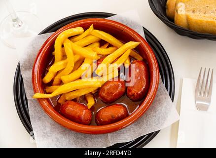 Popular Spanish tapa of smoked chorizo cooked in cider Stock Photo - Alamy