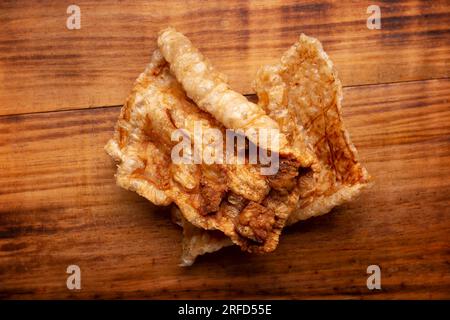 Chicharron. Crispy Fried pork rind, are pieces of aired and fried pork skin, traditional Mexican ingredient or snack. Table topview. Stock Photo