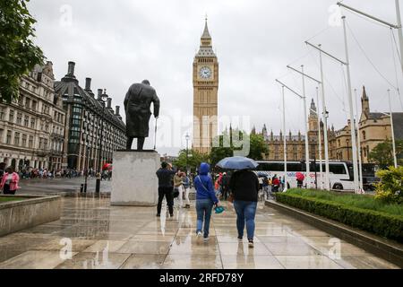 London, UK. 2nd Aug, 2023. People brave the rain near Big Ben in London, Britain, on Aug. 2, 2023. A yellow alert for storms stretching from London to Manchester and covering much of the Midlands and Wales was issued by the Met Office on Wednesday. Credit: Xinhua/Alamy Live News Stock Photo